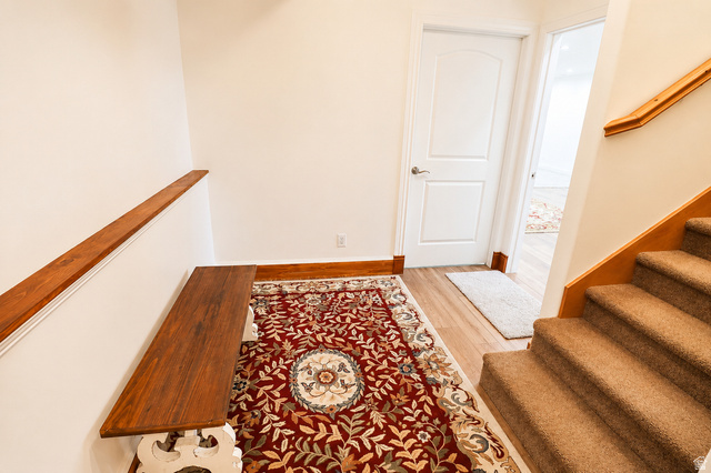 1055 North 1000 East Mapleton, UT 84664 - Photo 50 of 112 Carpeted staircase with light wood handrail