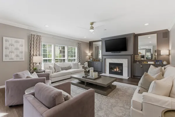 a living room with furniture a fireplace and a flat screen tv