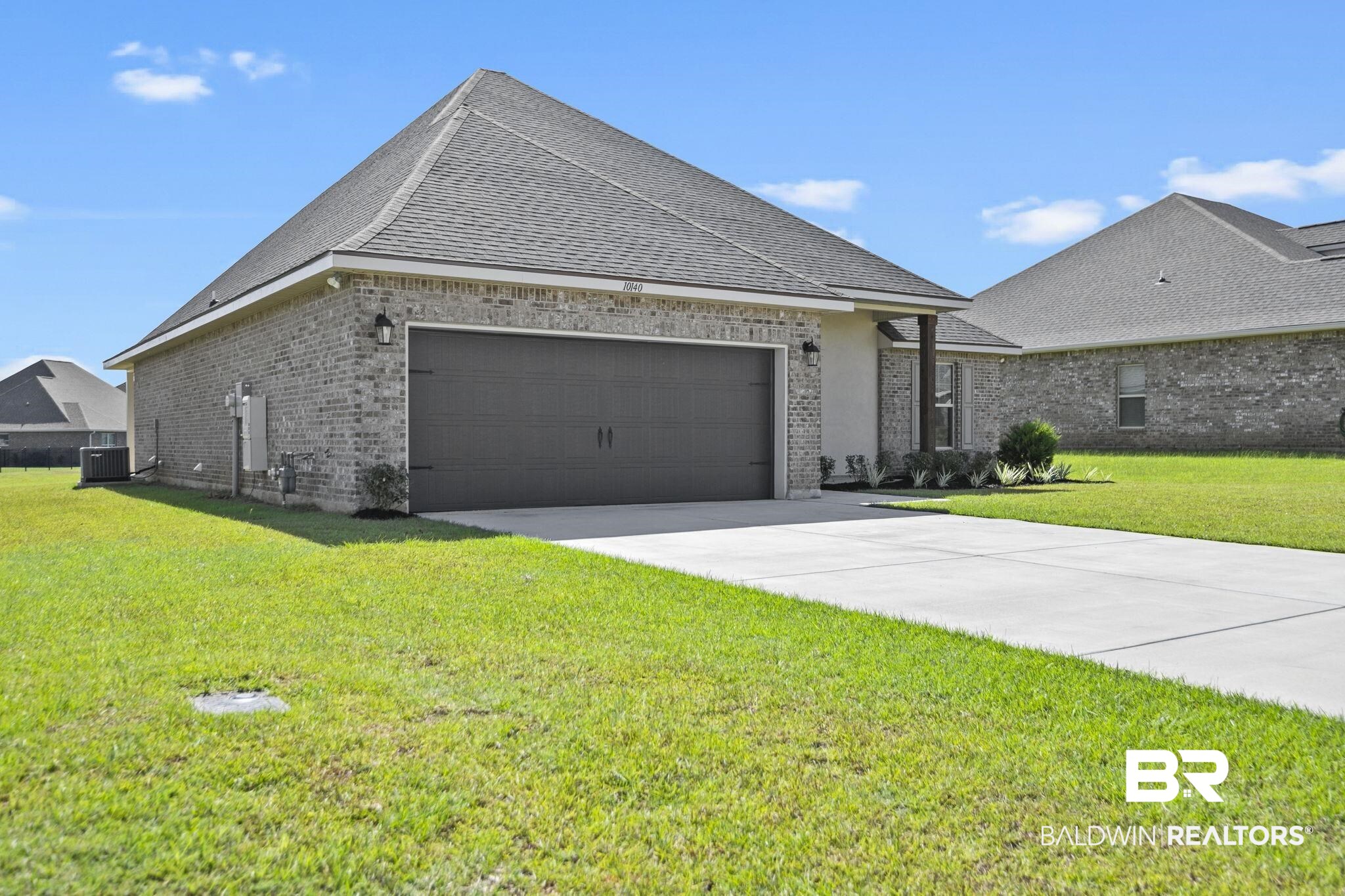 10140 Chipper Lane Foley, AL 36535 - Photo 5 of 72 View of front of home featuring a garage, a front lawn, and central AC unit