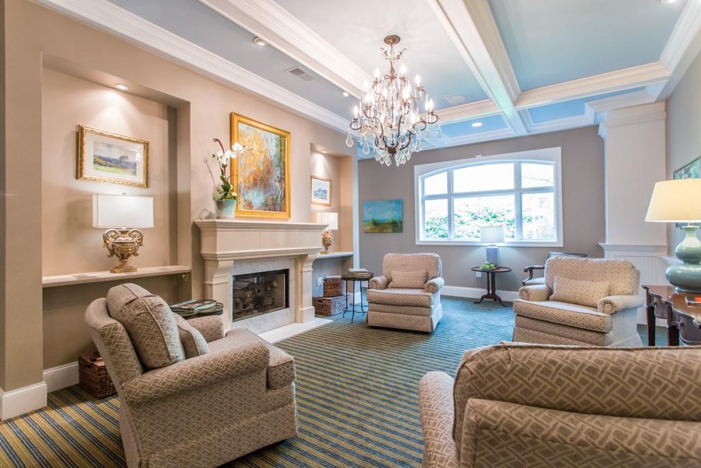 1800 Clairmont Lake, Unit 205 Decatur, GA 30033 - Photo 11 of 13 a living room with furniture a chandelier and a fireplace