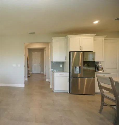 a kitchen with a refrigerator and a sink