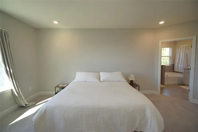 a bedroom with a bed and a view of balcony