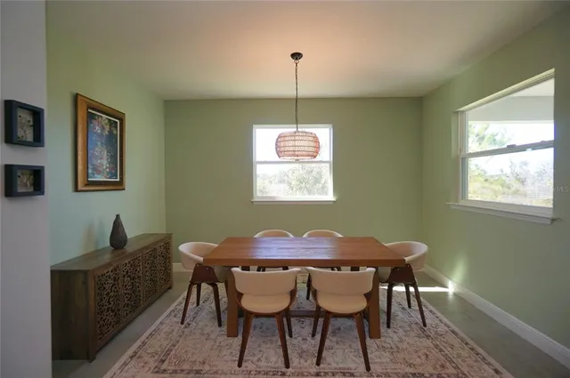 a dining room with furniture and window