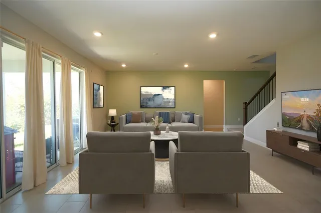 a living room with furniture and a large window