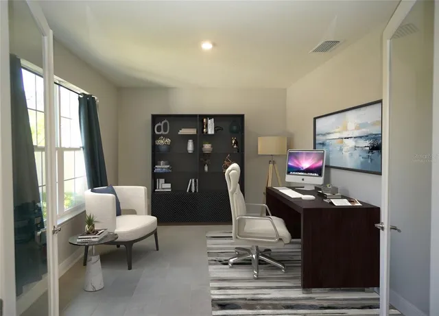 a view of a workspace with furniture and a window