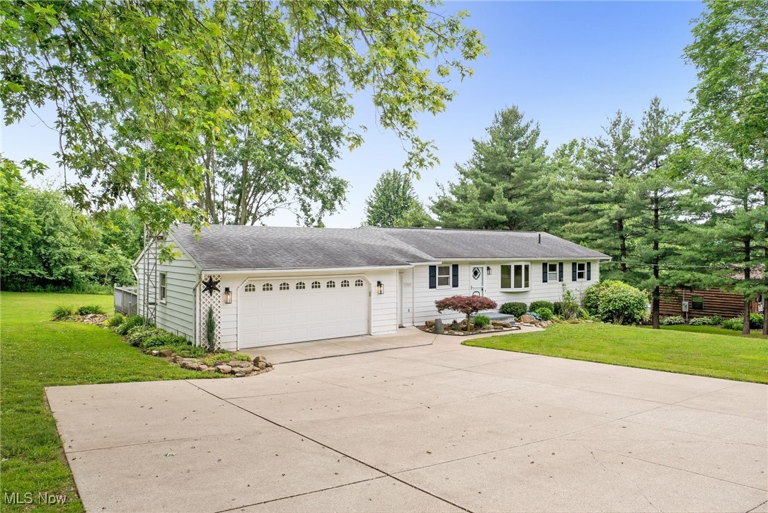 7923 Zigler Road Sterling, OH 44276 - Photo 2 of 31 View of front facade featuring driveway, a garage, and a front yard