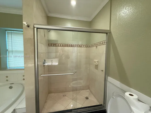 a bathroom with a shower and a mirror