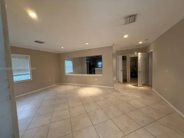 a view of an empty room and a window