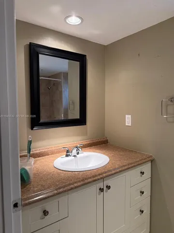 a bathroom with a sink and a mirror