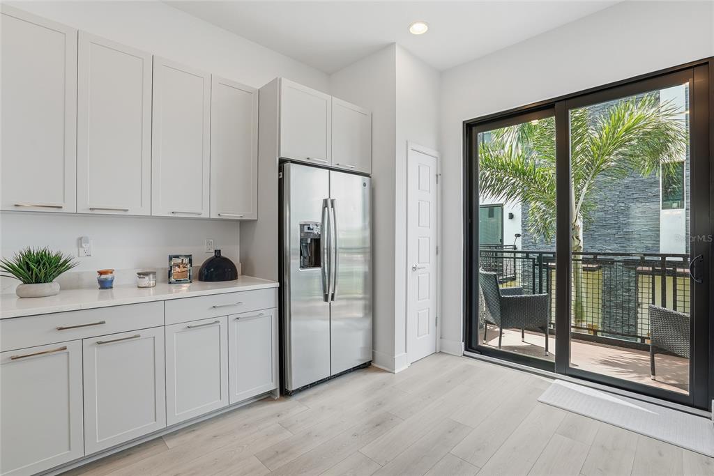 4810 West McElroy Avenue, Unit 30 Tampa, FL 33611 - Photo 20 of 43 a kitchen with white cabinets and a refrigerator