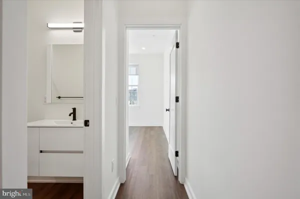 a view of a hallway with wooden floor