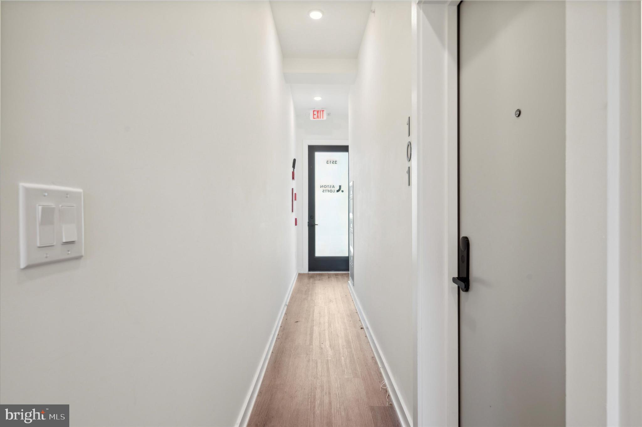 2513 North Howard Street, Unit 303 Philadelphia, PA 19133 - Photo 16 of 24 a view of a hallway with wooden floor and a bathroom