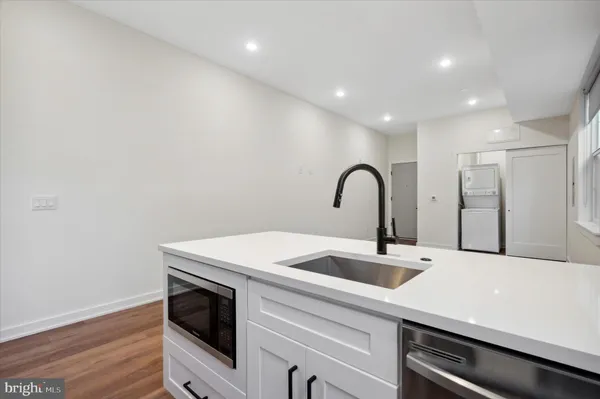 a kitchen with a sink and a hard wood floor