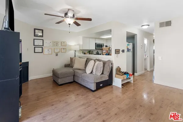 a living room with furniture and kitchen view