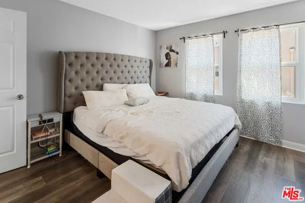 a bedroom with a bed and a night stand