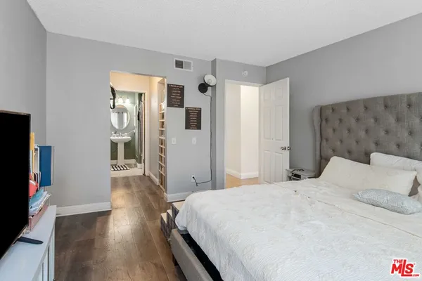 a bedroom with a bed and a flat screen tv