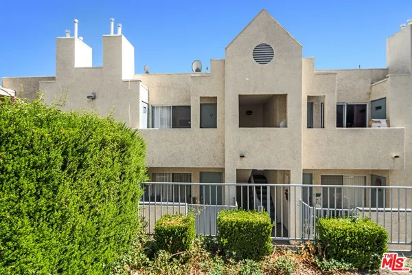 a front view of a building with a garden