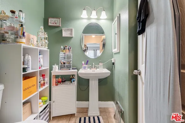 a bathroom with a sink a mirror and a toilet