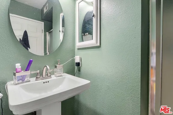 a bathroom with a sink and mirror