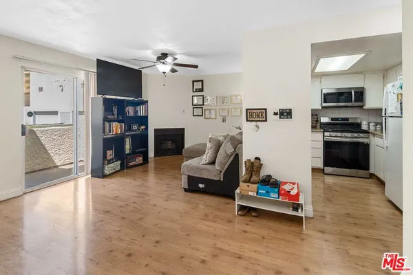 a living room with furniture and a kitchen area