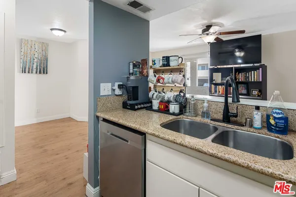 a kitchen with a sink and a refrigerator