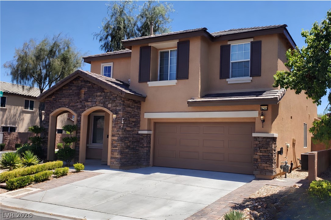 7903 Dell Ridge Avenue Las Vegas, NV 89179 - Photo 1 of 20 A stone-accented facade and inviting entry highlight this charming two-story residence.