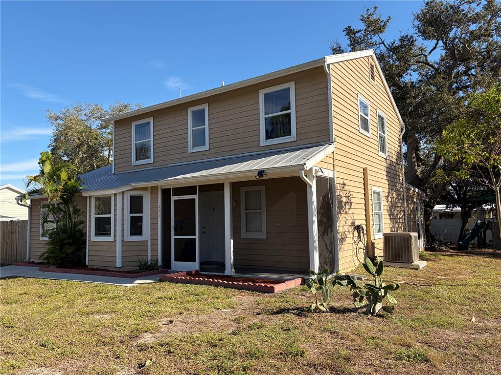 a view of a house with yard and sitting area