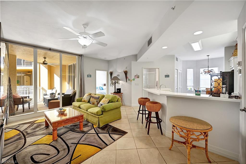 410 Bayfront Place, Unit 2409 Naples, FL 34102 - Photo 4 of 23 a living room with furniture and a chandelier