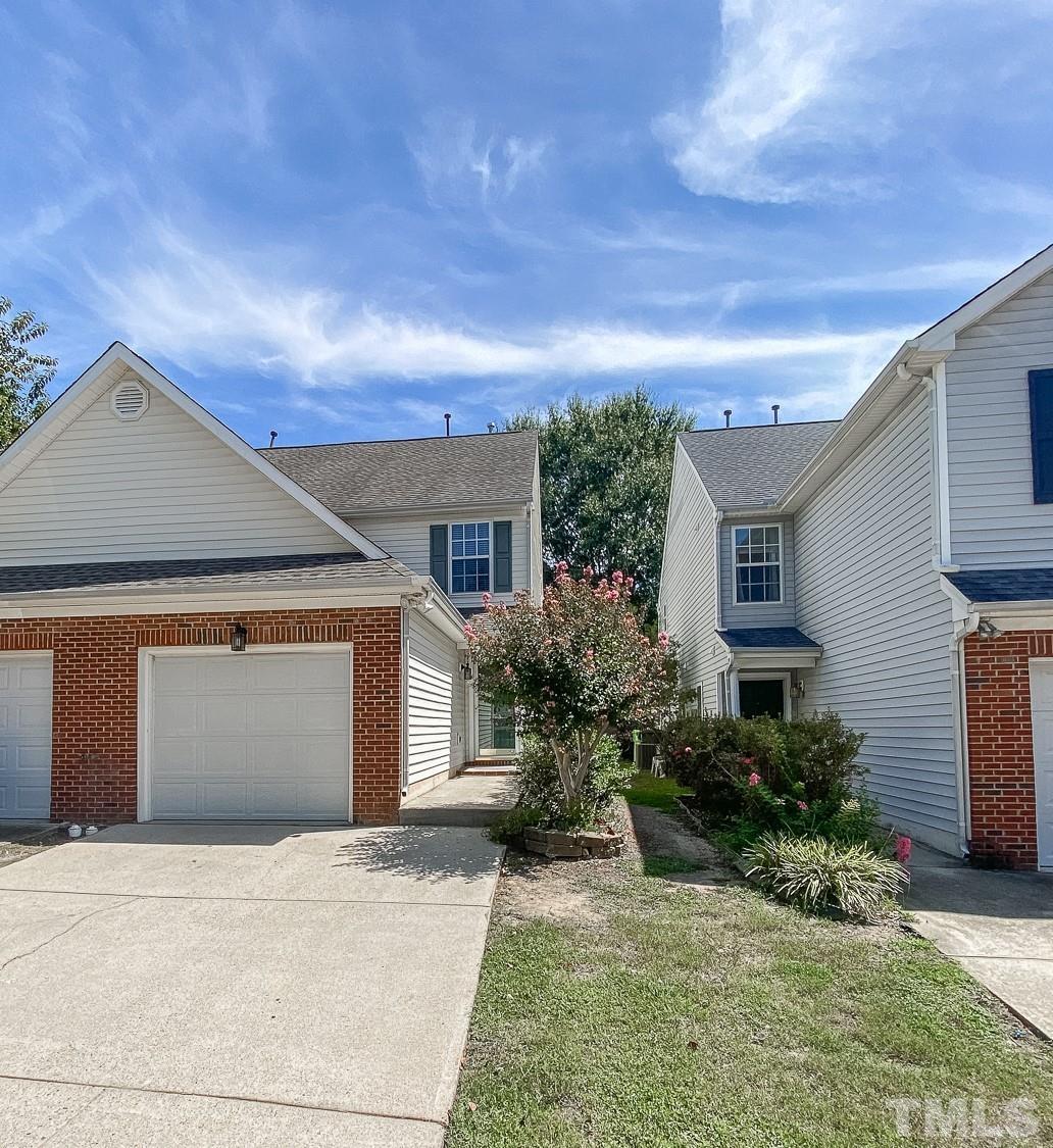 5242 Eagle Trace Drive Raleigh, NC 27604 - Photo 1 of 24 a front view of a house with a yard and garage