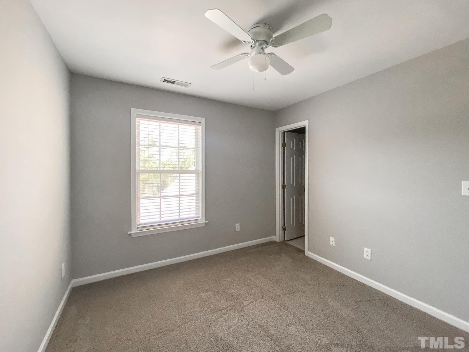 5242 Eagle Trace Drive Raleigh, NC 27604 - Photo 11 of 24 an empty room with windows and fan