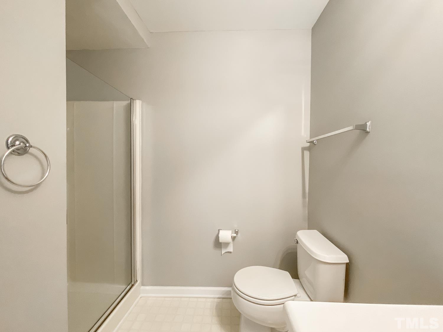 5242 Eagle Trace Drive Raleigh, NC 27604 - Photo 14 of 24 a white toilet sitting next to a bathroom sink and vanity