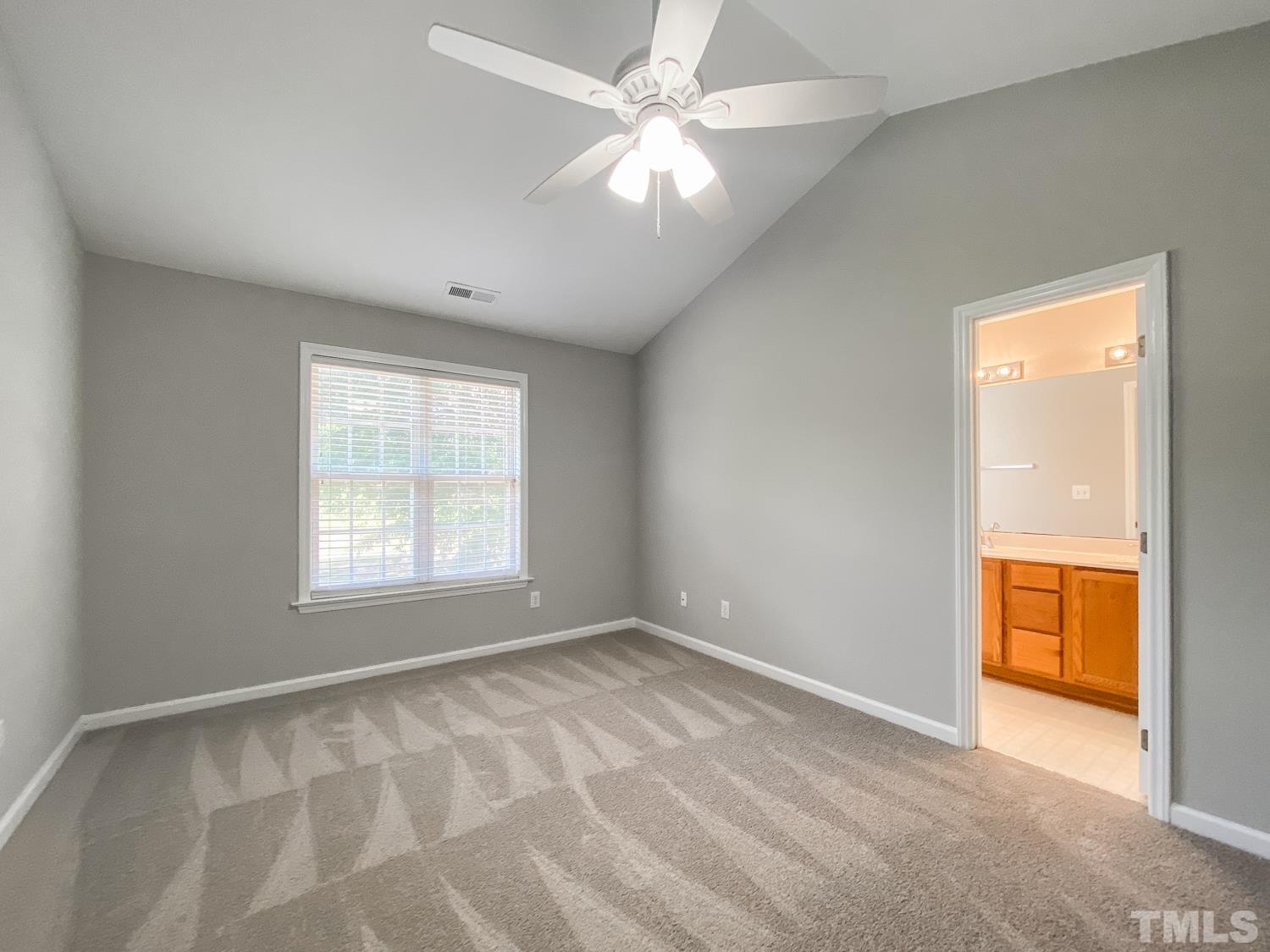 5242 Eagle Trace Drive Raleigh, NC 27604 - Photo 17 of 24 an empty room with a window and a ceiling fan
