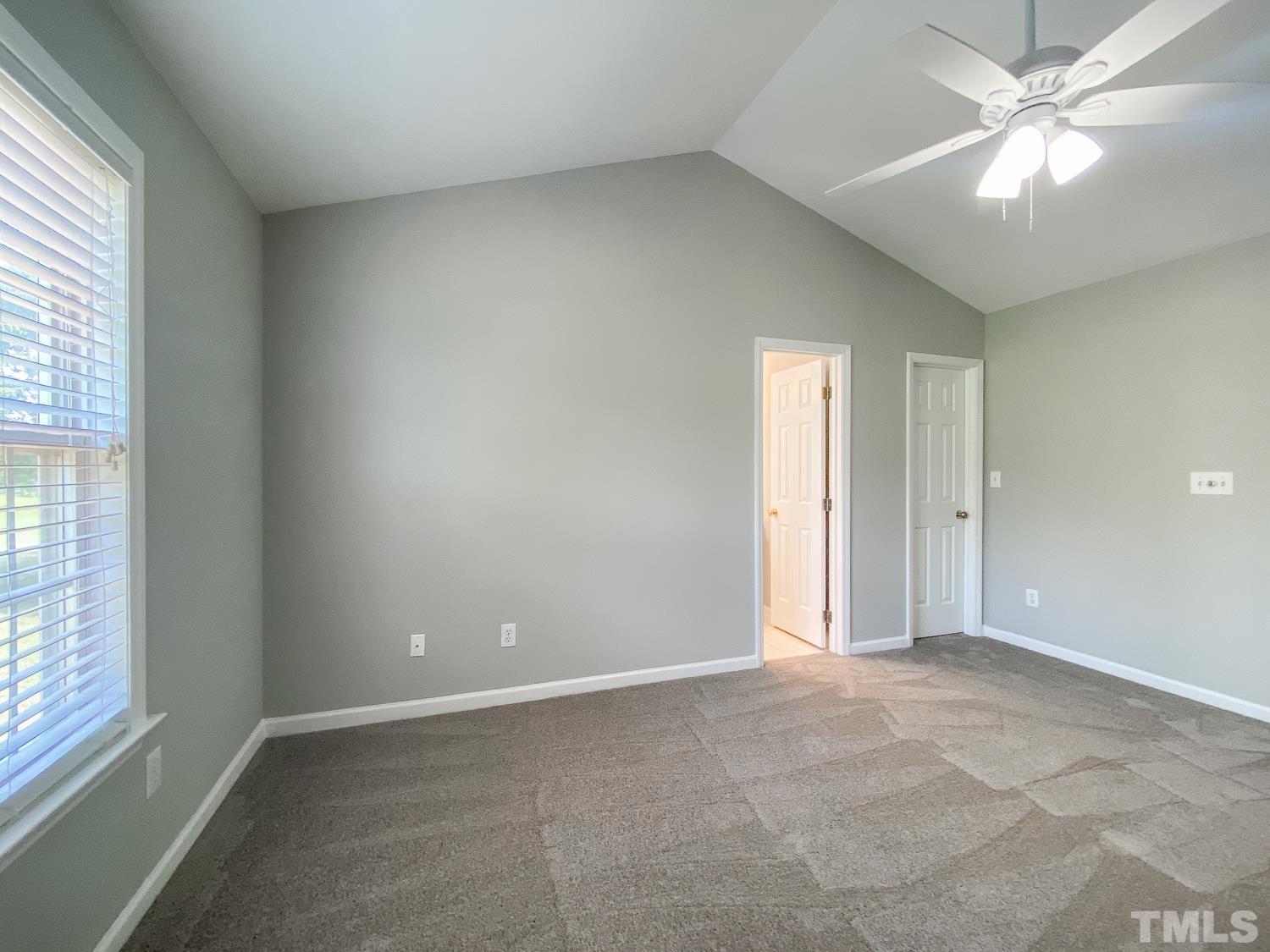 5242 Eagle Trace Drive Raleigh, NC 27604 - Photo 18 of 24 an empty room with windows and fan