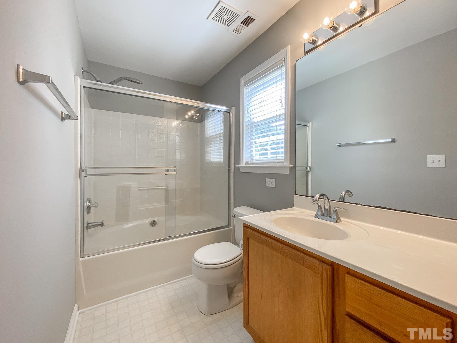 5242 Eagle Trace Drive Raleigh, NC 27604 - Photo 19 of 24 a bathroom with a sink a toilet and shower