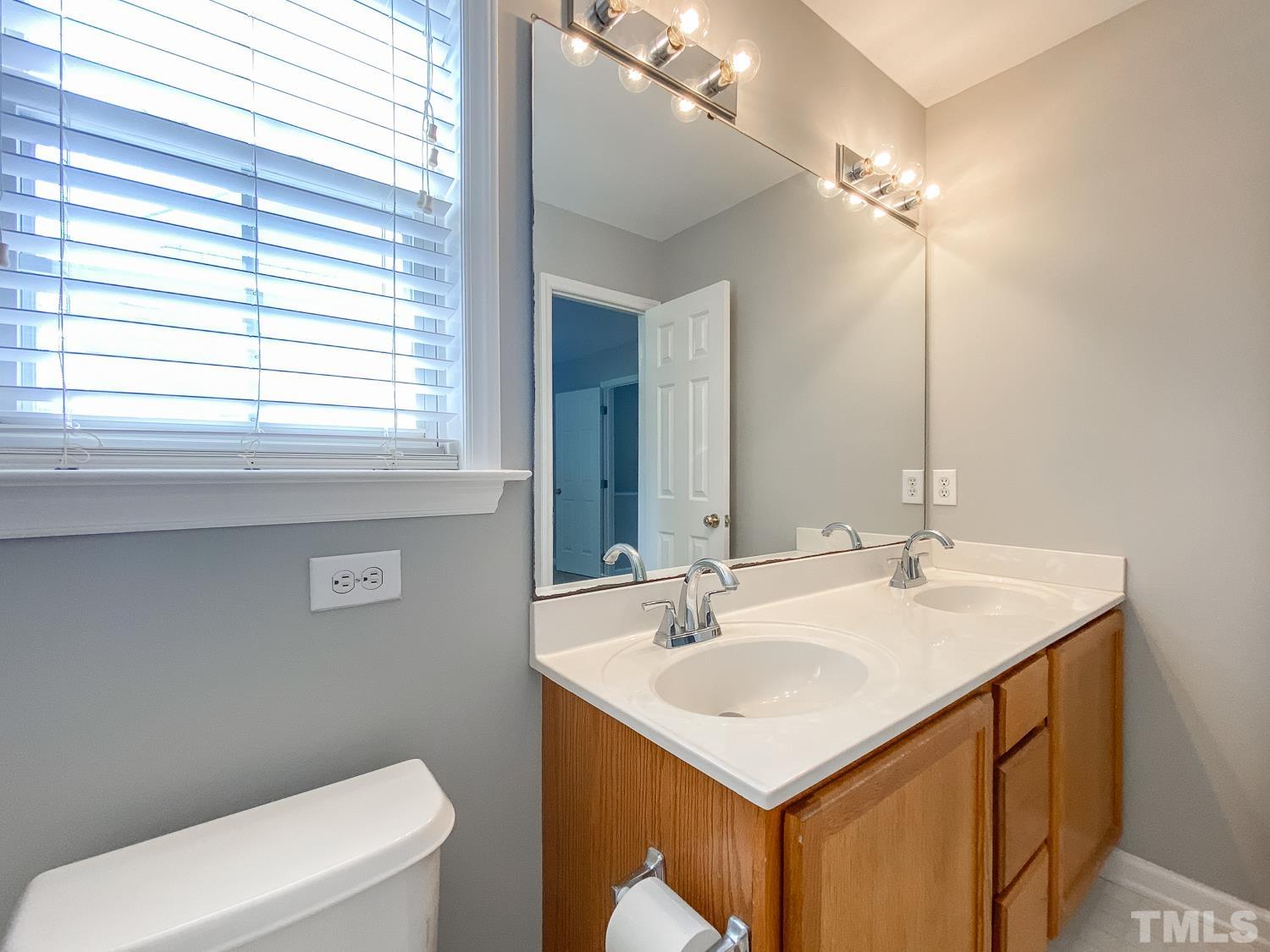 5242 Eagle Trace Drive Raleigh, NC 27604 - Photo 20 of 24 a bathroom with a sink and a toilet