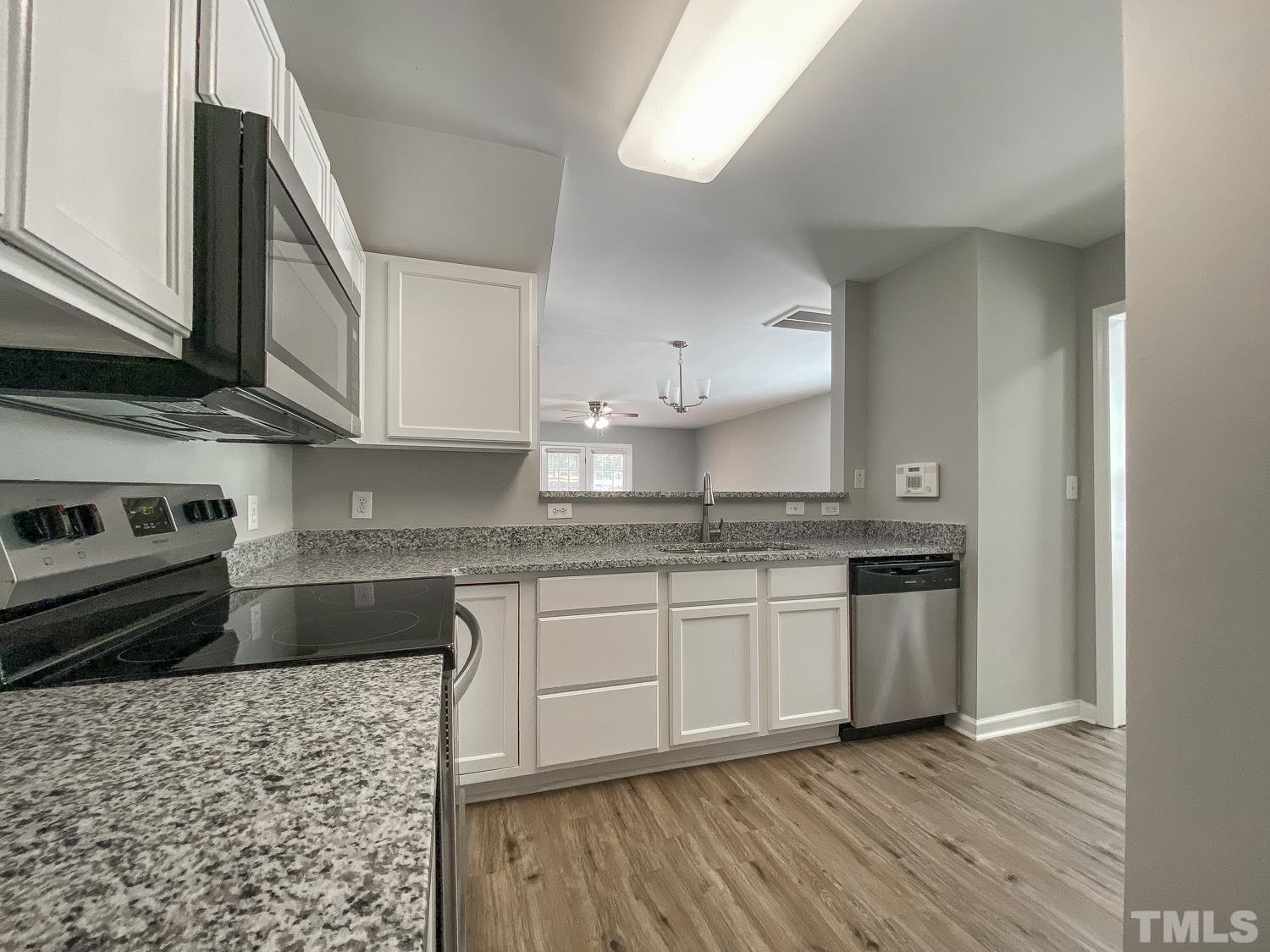 5242 Eagle Trace Drive Raleigh, NC 27604 - Photo 4 of 24 a kitchen with stainless steel appliances granite countertop a stove and a sink