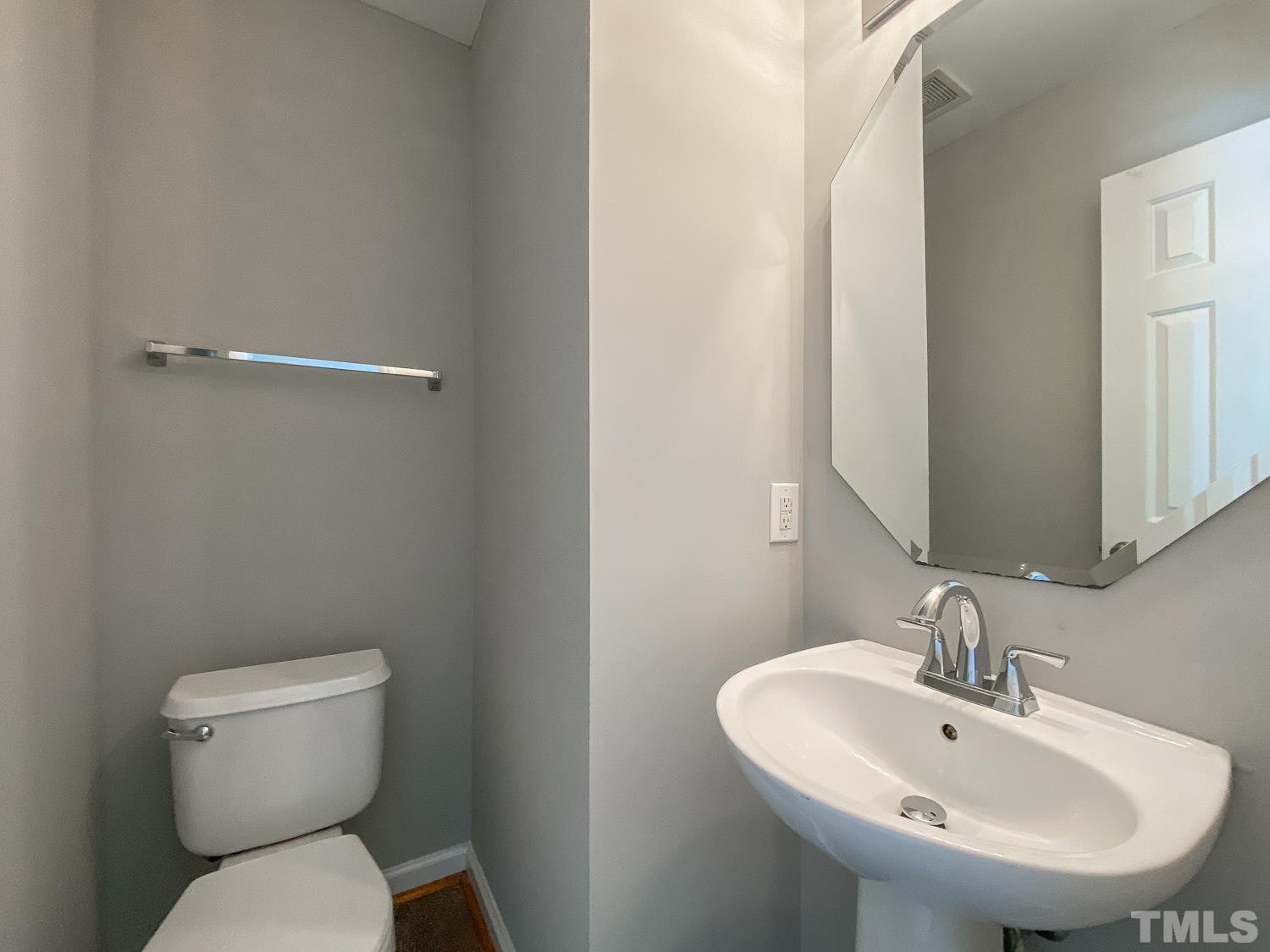 5242 Eagle Trace Drive Raleigh, NC 27604 - Photo 6 of 24 a bathroom with a toilet sink and mirror