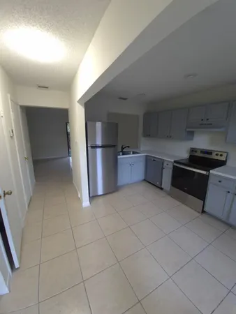 a kitchen with stainless steel appliances granite countertop a refrigerator and a stove