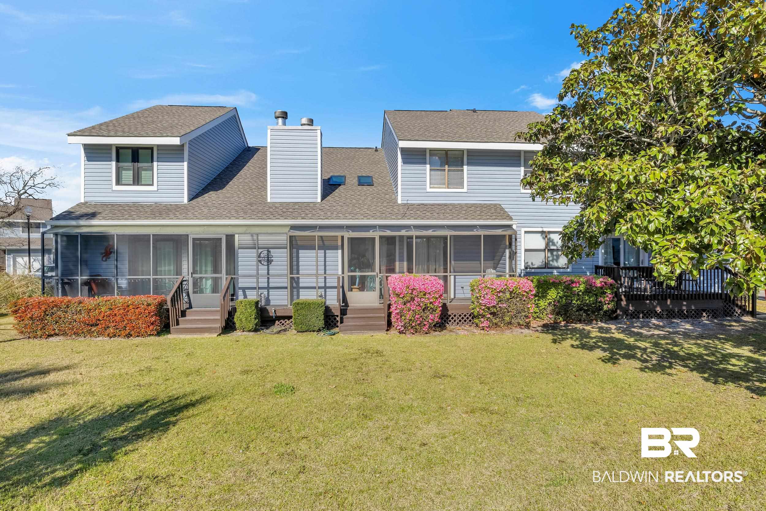 3256 Loop Road, Unit 2 Orange Beach, AL 36561 - Photo 4 of 25 Rear exterior featuring two screened porches, a private outdoor deck, siding facade, and a shingled roof