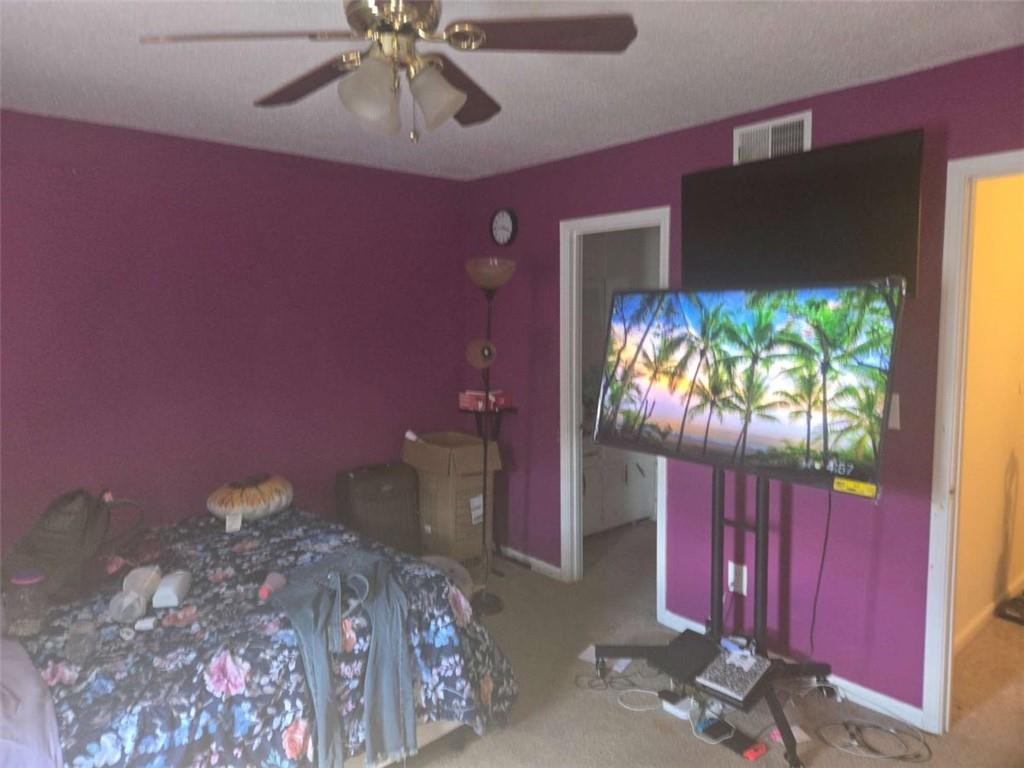 3647 Cobble Mill Lane Clarkston, GA 30021 - Photo 11 of 19 a bedroom with a bed and a chandelier