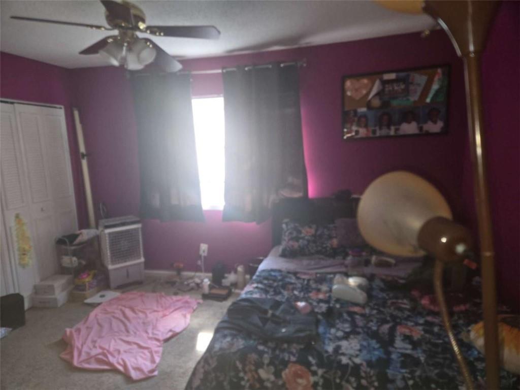 3647 Cobble Mill Lane Clarkston, GA 30021 - Photo 12 of 19 a bedroom with bed and a chandelier