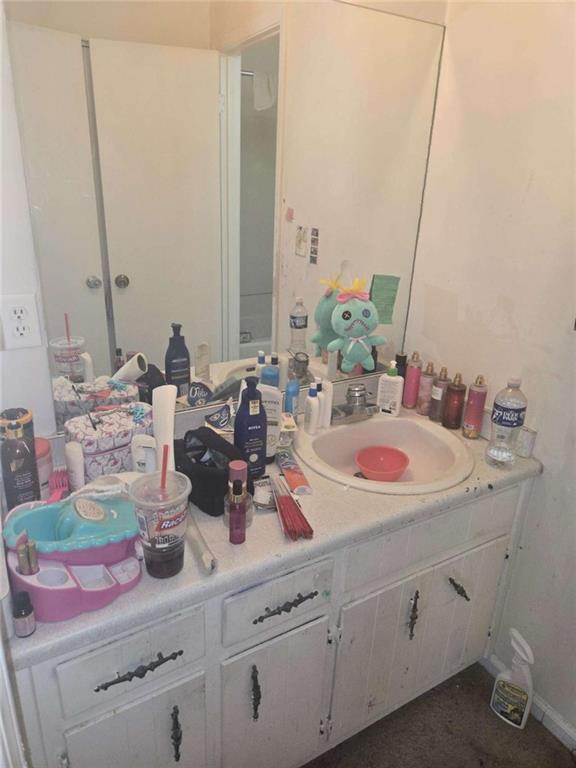 3647 Cobble Mill Lane Clarkston, GA 30021 - Photo 19 of 19 a bathroom with a sink and a mirror