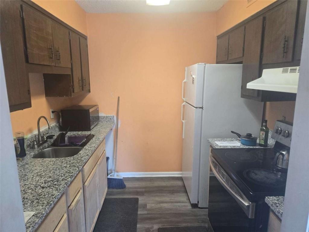 3647 Cobble Mill Lane Clarkston, GA 30021 - Photo 4 of 19 a kitchen with granite countertop a sink stove and refrigerator