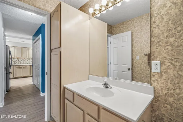 a view of empty room with wooden floor and window