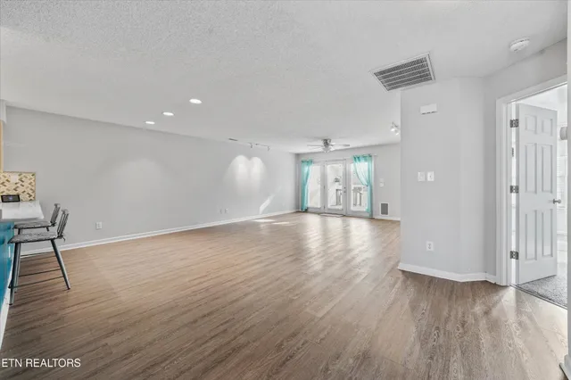 a view of a backyard with wooden fence