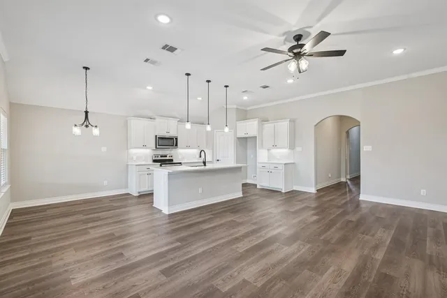 a large kitchen with cabinets a sink and dishwasher