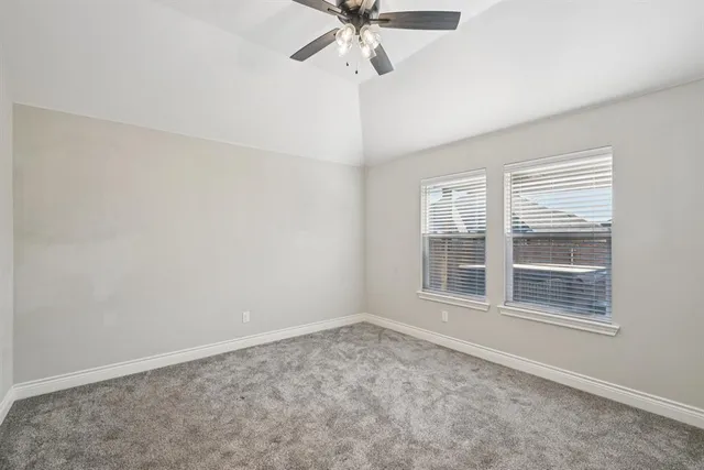 an empty room with closet and windows