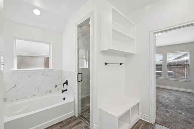 a bathroom with a double vanity sink a mirror and a shower