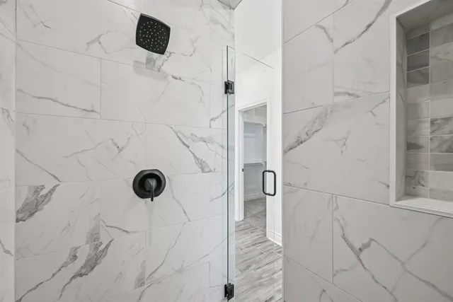 a bathroom with a bathtub and shower