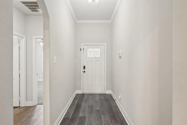 a view of a hallway with wooden floor